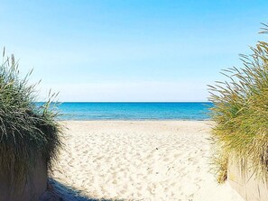 A sandy beach with clear blue water and a clear sky. - 4 Star Holiday Home in Skummeslovsstrand (Skummesloevsstrand)