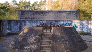 A concrete structure with graffiti, a staircase, and a forested background. - 6 Person Holiday Home in Nexo (Nexø)
