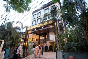 The entrance to Hotel Radiante Courtyard with a modern design, featuring a glass facade and a welcoming entrance. - RADIANCE COURTYARD (Varanasi)