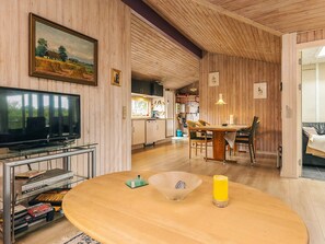 A cozy living room with a TV, wooden furniture, and a dining area. - 10 Person Holiday Home in Storvorde (Storvorde)