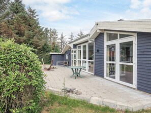 A house with a patio, a table, and chairs. - 10 Person Holiday Home in Storvorde (Storvorde)