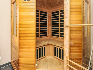 A wooden sauna with a bench, a bench with a backrest, and a bench with a backrest. - 10 Person Holiday Home in Storvorde (Storvorde)