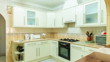 Villa | Private kitchen | Fridge, highchair