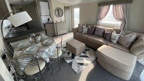 A compact living space with a kitchenette, dining area, and seating area.