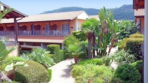 A resort with multiple buildings, a paved pathway, and lush greenery. - Futura Club La Praya (Pizzo)