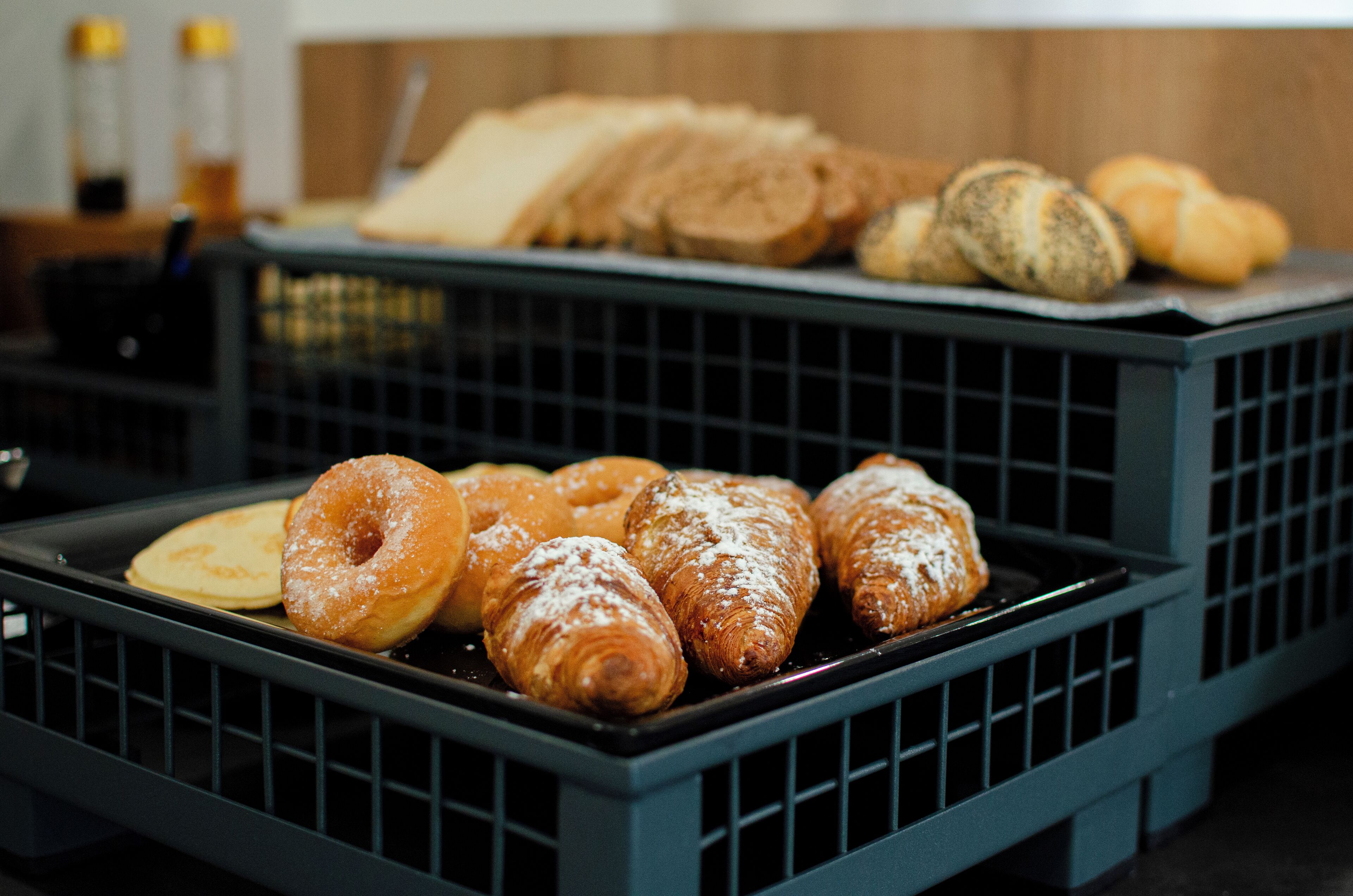 A display of pastries in a blue crate.