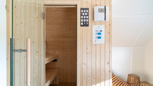 A sauna room with wooden walls and a bench. - Holiday Home in Scherpenisse Near Nature Reserve (Scherpenisse)