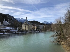 A river with buildings and mountains in the background.