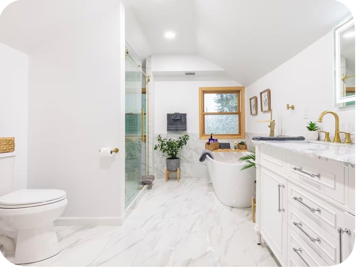 A modern bathroom with a toilet, a bathtub, and a vanity with a mirror.