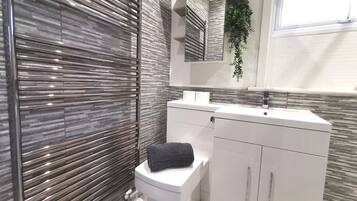 Shower, hair dryer, towels, shampoo