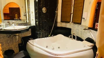 A bathroom with a bathtub, a sink, and a shower.