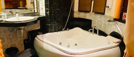 A bathroom with a bathtub, a sink, and a shower.