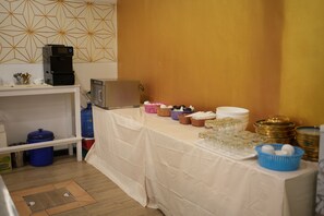 A kitchen area with a table set for a meal, a coffee machine, and a microwave. - Penthouse Pattaya (Pattaya)