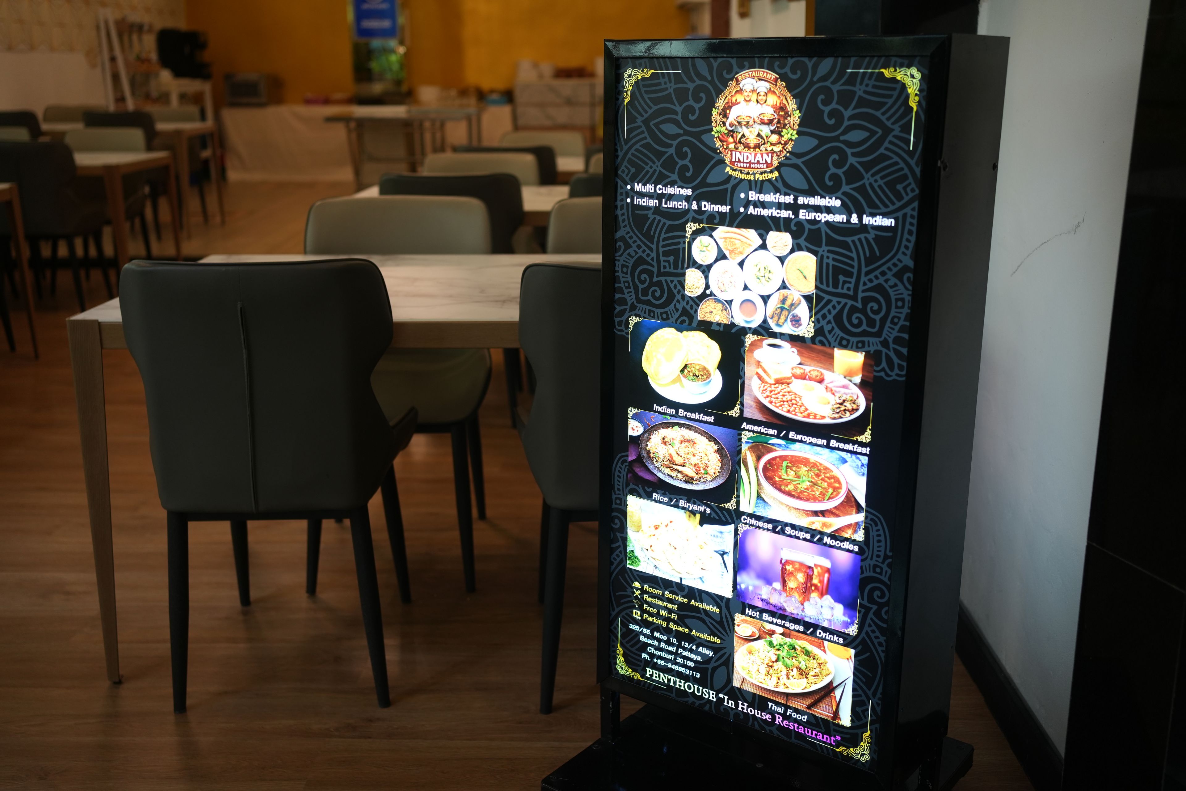 A digital menu board in a restaurant with various food options.