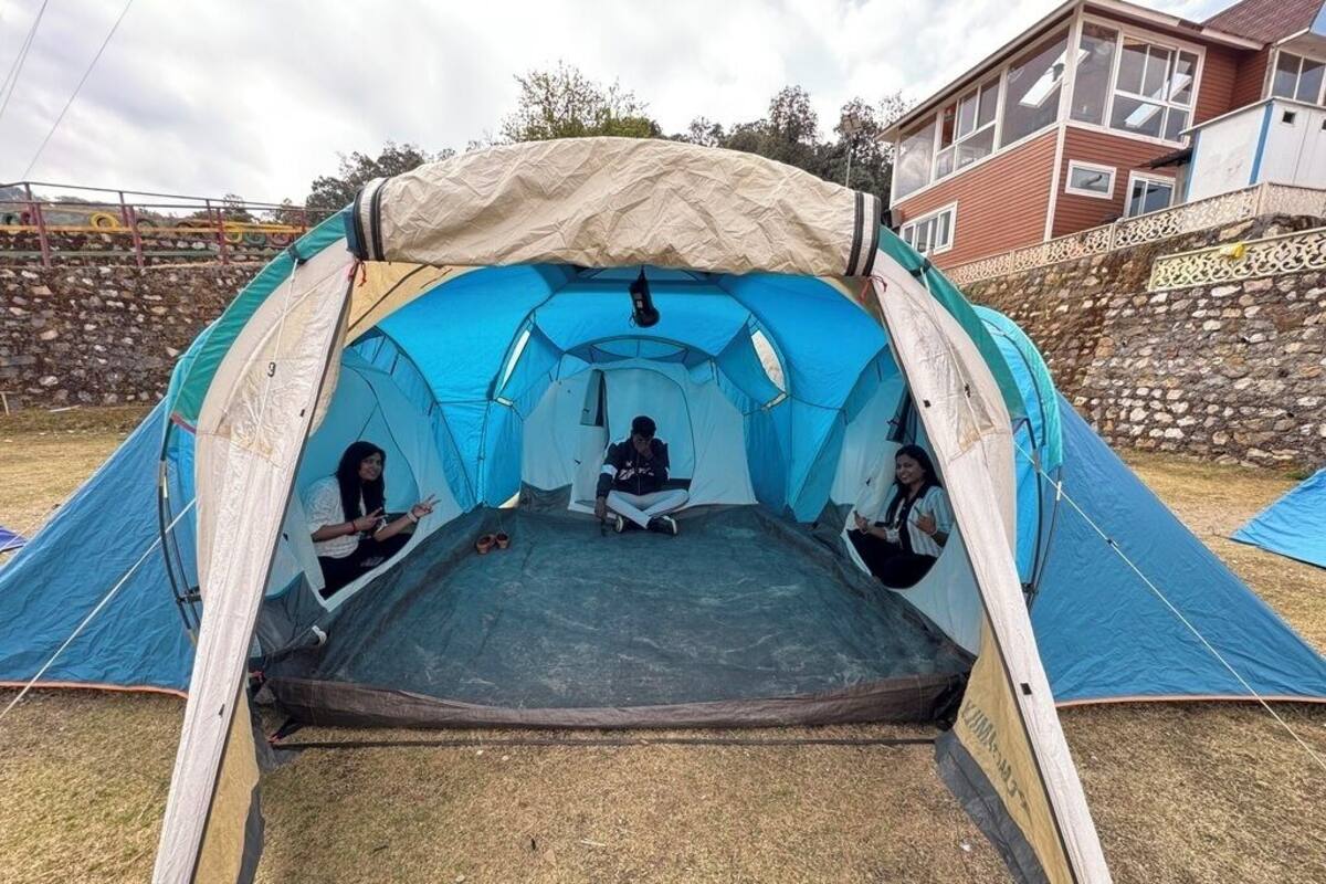 A large tent with a central sleeping area and a covered entrance.