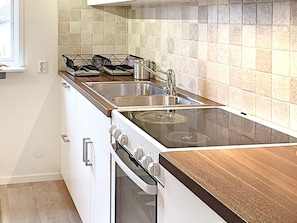 A kitchen with a stove, oven, and sink. - 4 Person Holiday Home in Enviken (Enviken)