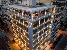 A multi-story hotel with balconies and a distinctive lightning bolt logo.