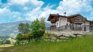 A traditional wooden chalet with a balcony, set against a mountainous backdrop. - Chalet in Gattererberg Near Ski Slopes (Stummerberg)