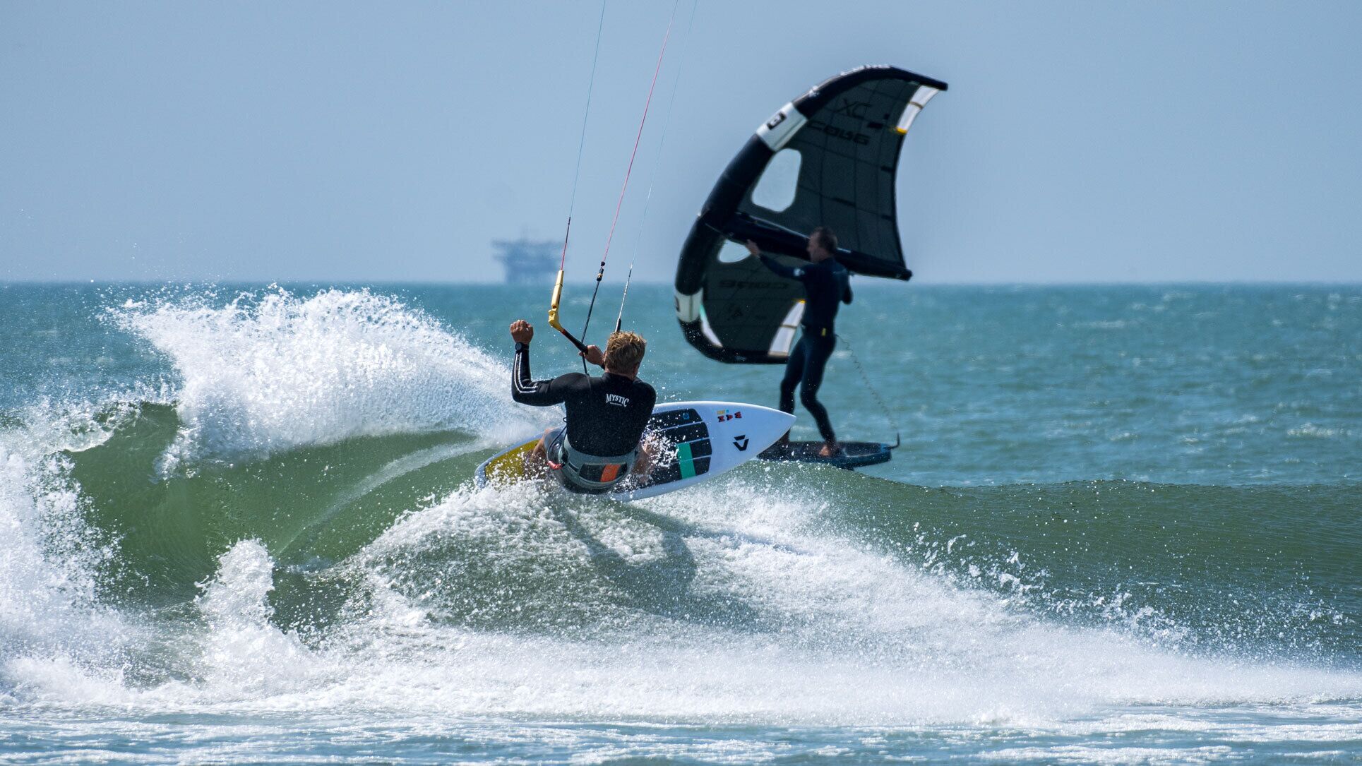 A person windsurfing on a surfboard in the ocean.