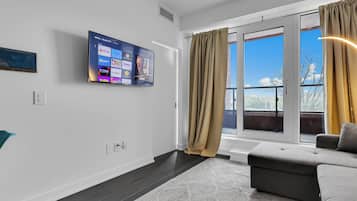 Luxury Condo, Balcony, Courtyard View | Living area | 55-inch Smart TV with digital channels