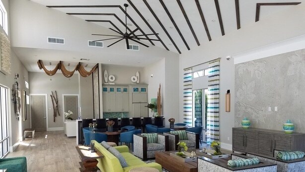 A spacious living area with modern furniture, a kitchen in the background, and a large window with curtains. - Luxurious 6bd Pool Haven Refreshing And Chic-4464n 6 Bedroom Home by RedAwning (Kissimmee)
