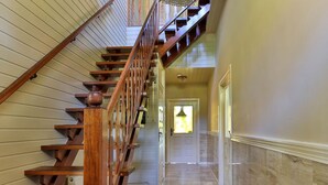 A wooden staircase with a handrail leading to a second-floor landing. - Characteristic House With Wellness in Augustinusga (Augustinusga)