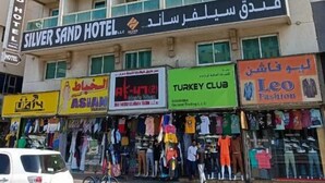 A multi-story building with a sign for the Silver Sand Hotel. - Silver Sand Hotel (Dubai)