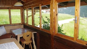 Une pièce dans un chalet en bois, comprenant un lit, une table et une chaise.