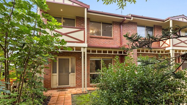 A two-story building with a brick facade, large windows, and a visible balcony. - Simpson Getaway 1 - Point Lonsdale (Point Lonsdale)