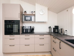 A modern kitchen with a Bosch oven, a microwave, a toaster, and a coffee maker.