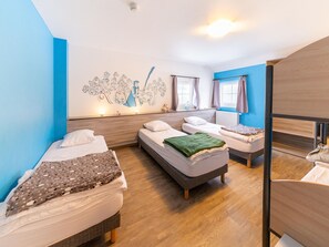 A modern hotel room with three beds, a large wall mural, and a wooden floor. - Family Home, Kicker, Sunset Views (Trois-Ponts)