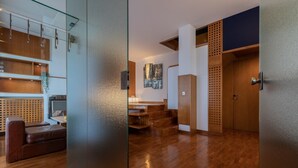 A modern interior with wooden flooring, a glass partition, and a staircase. - Villetta con Giardino Allo Stadio by Wonderful Italy (Turin)