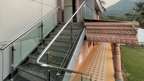 A modern building with a staircase leading to an entrance. - JP GARDEN & LAWN (Mumbai)