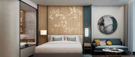 Una habitación de hotel moderna con una cama grande, un sofá, una mesa de centro y una obra de arte colgada en la pared.