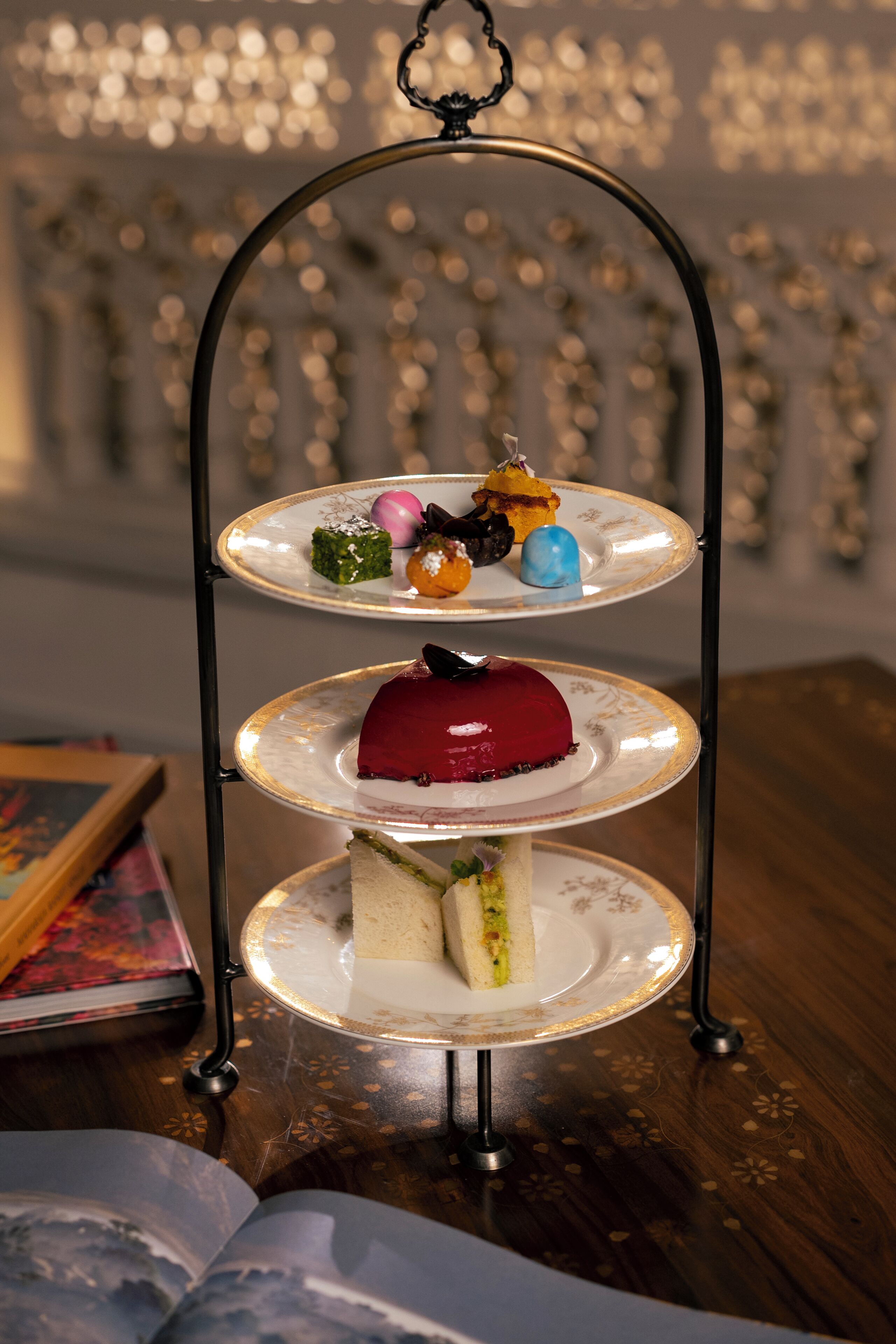 A three-tiered dessert stand with various sweets on each tier.