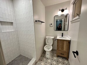 Shower, hair dryer, towels, shampoo
