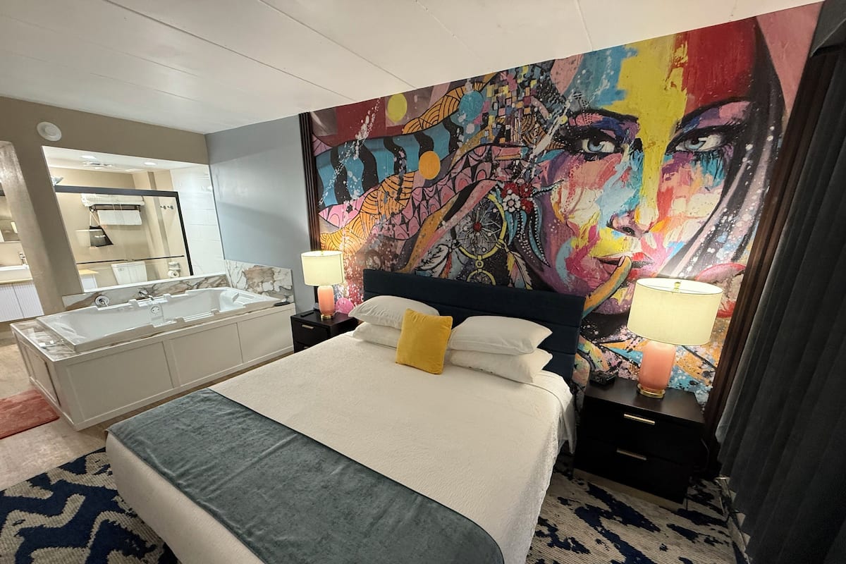 Deluxe Room | 1 bedroom, down comforters, blackout drapes, iron/ironing board
