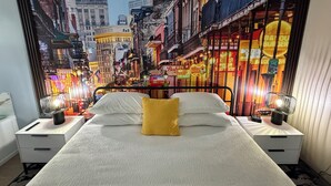 A bedroom with a bed centered between two nightstands, each with a lamp.