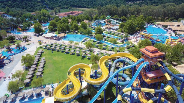 A water park with multiple slides and pools, surrounded by greenery and hills. - Holiday Villa Martini With Pool, in Ermones Beach, Vatos, Corfu (Corfu)