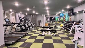 A gym with treadmills, elliptical machines, weight benches, and free weights. - The Vault - Perfect Location! (Oxford)