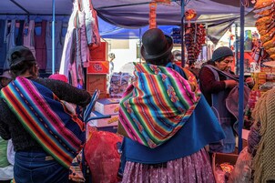 Un puesto de mercado con varios artículos a la venta, incluyendo cajas y bolsas.