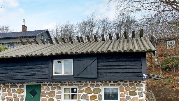 A stone house with a green door, two windows, and a number '2C' on the side. - 4 Star Holiday Home in Bastad (Bastad)