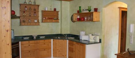 A kitchen with wooden cabinets, a countertop, and a sink.