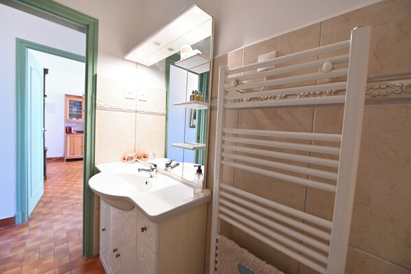 A bathroom with a white sink, mirror, and towel rack. - VERY NICE 2 ROOMS NEAR THE SEA (Port-Vendres)