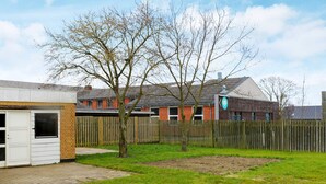 A residential area with a detached house, a garage, and a fenced yard. - 6 Person Holiday Home in Hadsund (Hadsund)