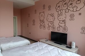 A hotel room with two beds, a TV, and a wall decorated with Hello Kitty and bear designs.
