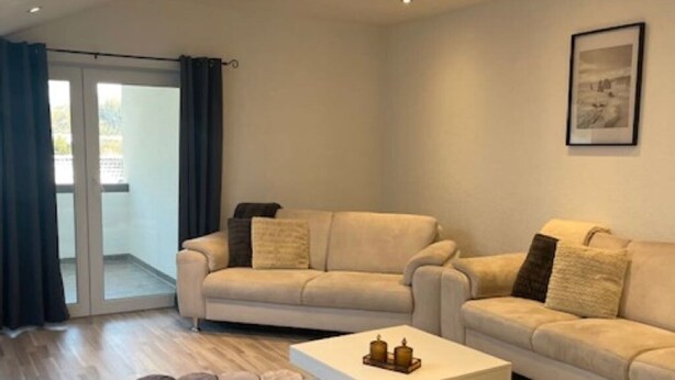 A modern living room with two sofas, a coffee table, and a patterned rug. - Baba Apart 1 Große, Moderne Wohnung Direkt an der Schweizer Grenze (Laufenburg)