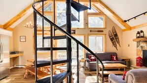 A spacious loft with a wooden interior, a spiral staircase, and large windows offering views of the outdoors. - Walk to Lake Harmony l FREE Beach Access l Hot Tub (Lake Harmony)