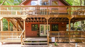 A two-story wooden cabin with a balcony, a front porch, and a stone chimney. - Walk to Lake Harmony l FREE Beach Access l Hot Tub (Lake Harmony)