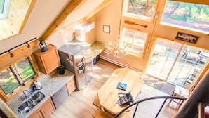 A compact kitchen with a refrigerator, sink, and wooden dining table. - Walk to Lake Harmony l FREE Beach Access l Hot Tub (Lake Harmony)